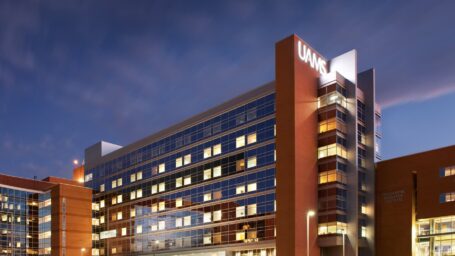 The UAMS campus in Little Rock at night, with the bright UAMS letter illuminated on the building.
